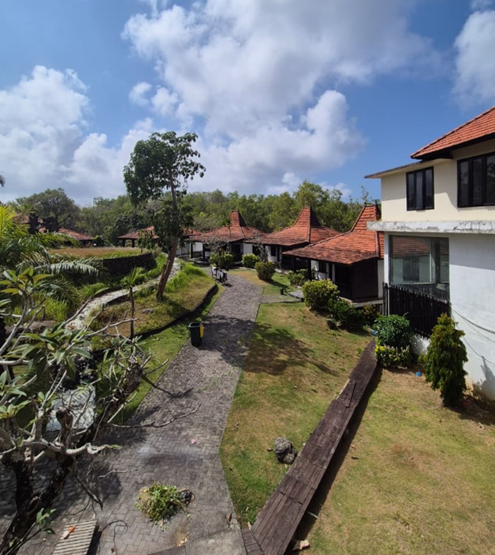 Melasti freehold plot, Bali: paved path between existing pavilions and a two-storey building